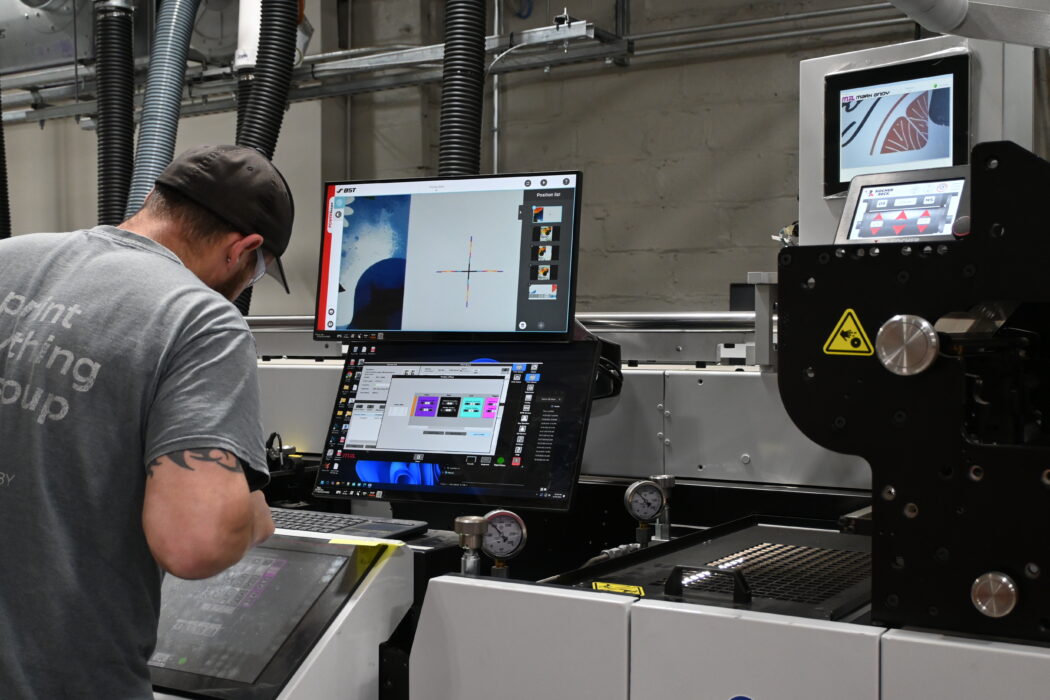 Steinhauser press operator looking at quality on the Mark Andy hybrid press