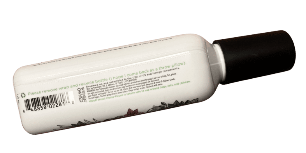 Poo-pourri bottle showcasing where there is a perforation on a shrink sleeve label and call out for how to remove wrap and recycle bottle