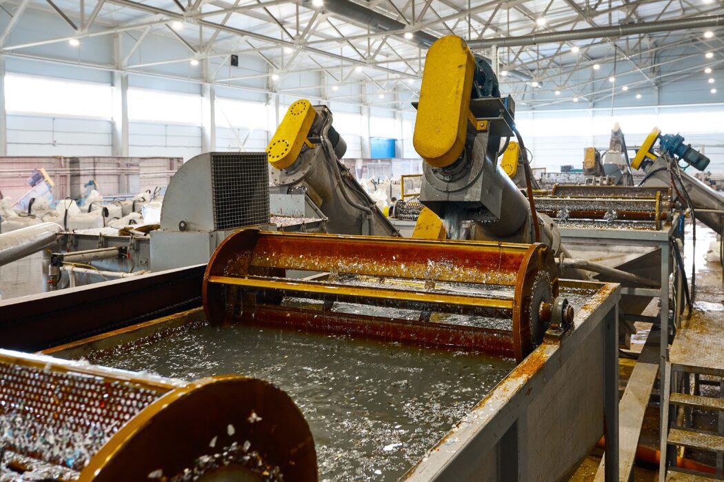 Automatic machine Bath for washing shredded plastic. in materials reprocessing workshop. Eco friendly production industry. 