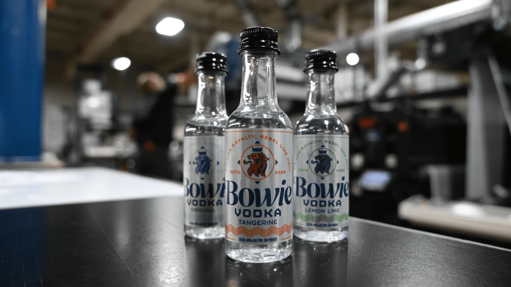 3 SKUs of pressure sensitive spirits label applied to airplane bottles and arranged in production area